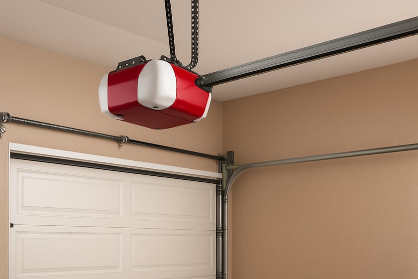 Product shot of a belt drive garage door opener mounted above a closed door, for the article What Drives the Price of Garage Door Opener Installation in Las Vegas, And What a Written Price Should List.